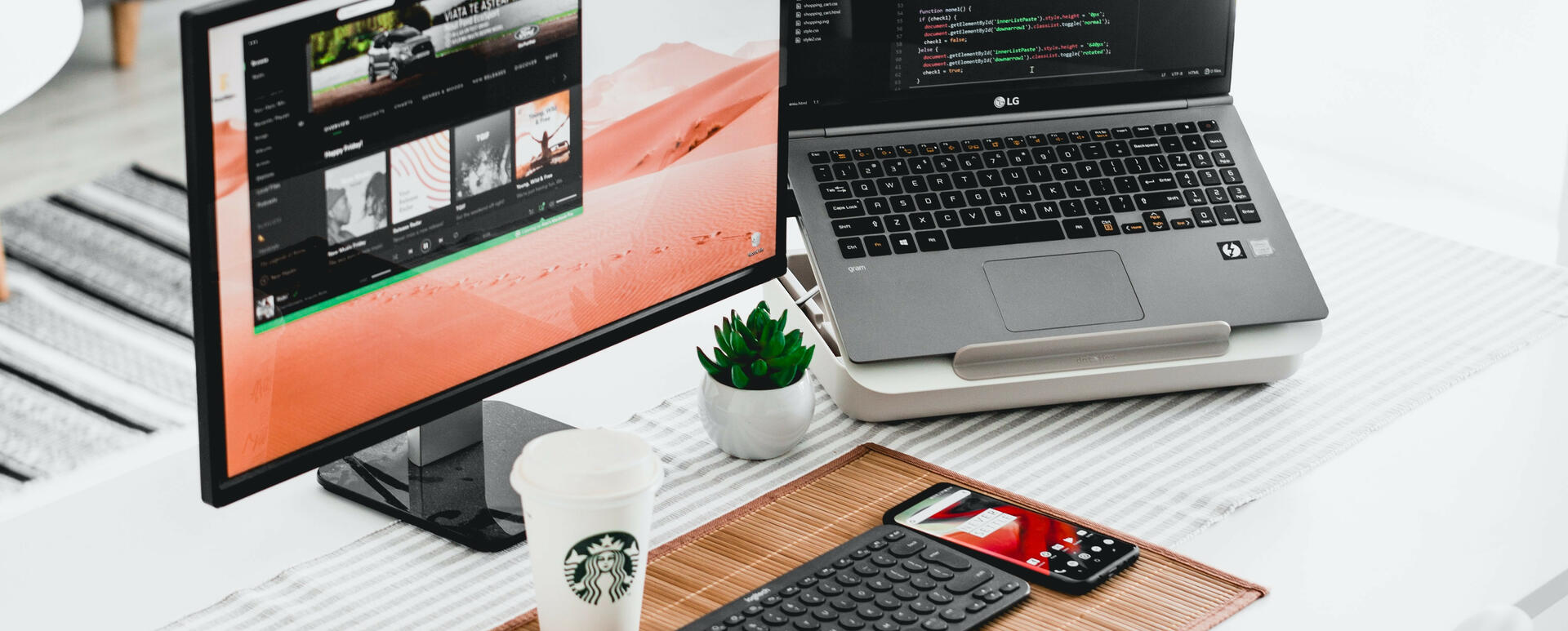 A desk with laptop and monitor