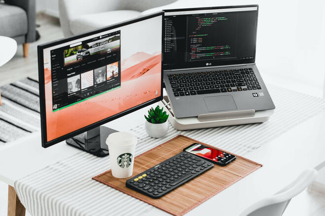 A desk with laptop and monitor